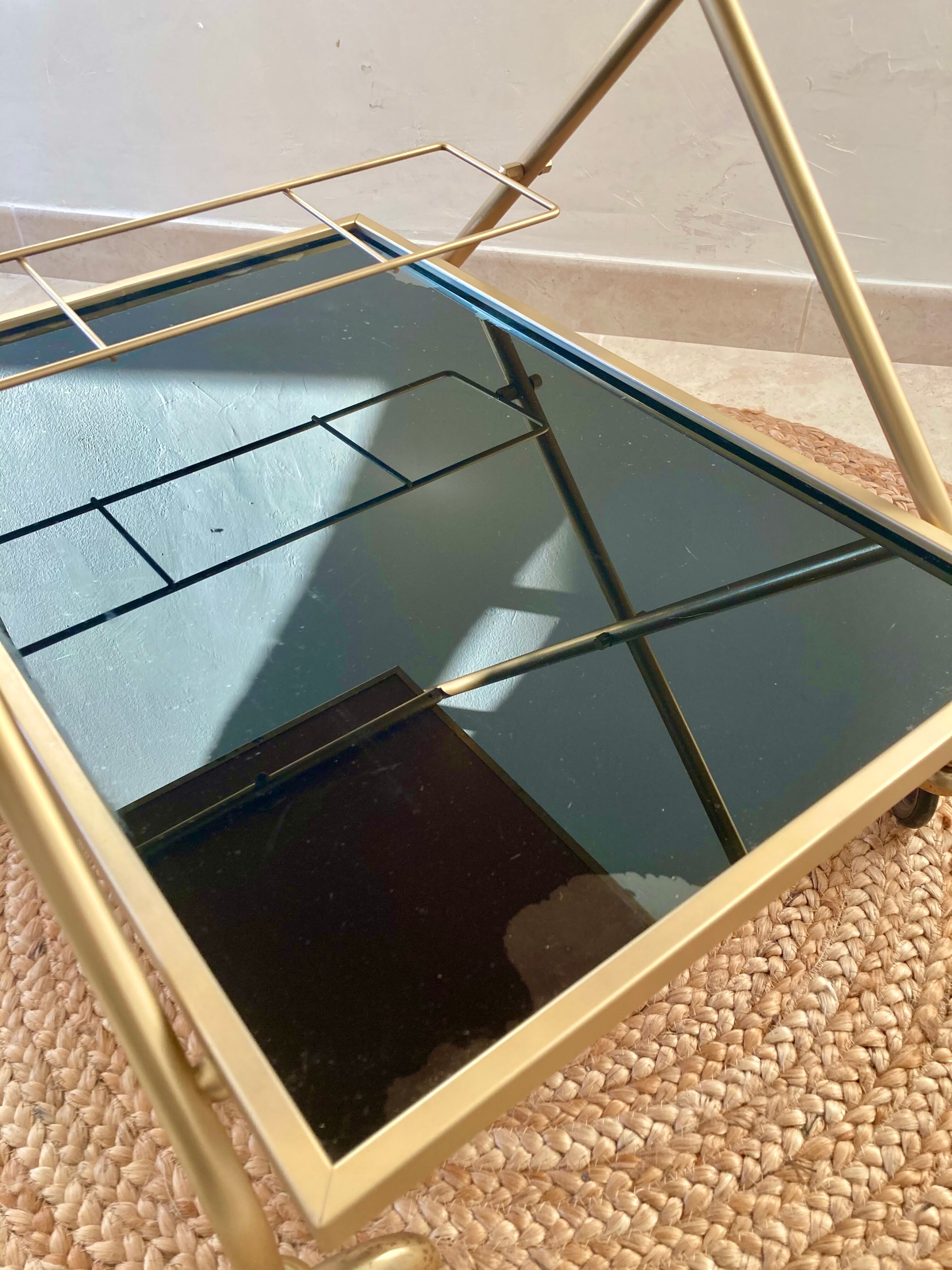 Golden dessert on wheels with black glass trays