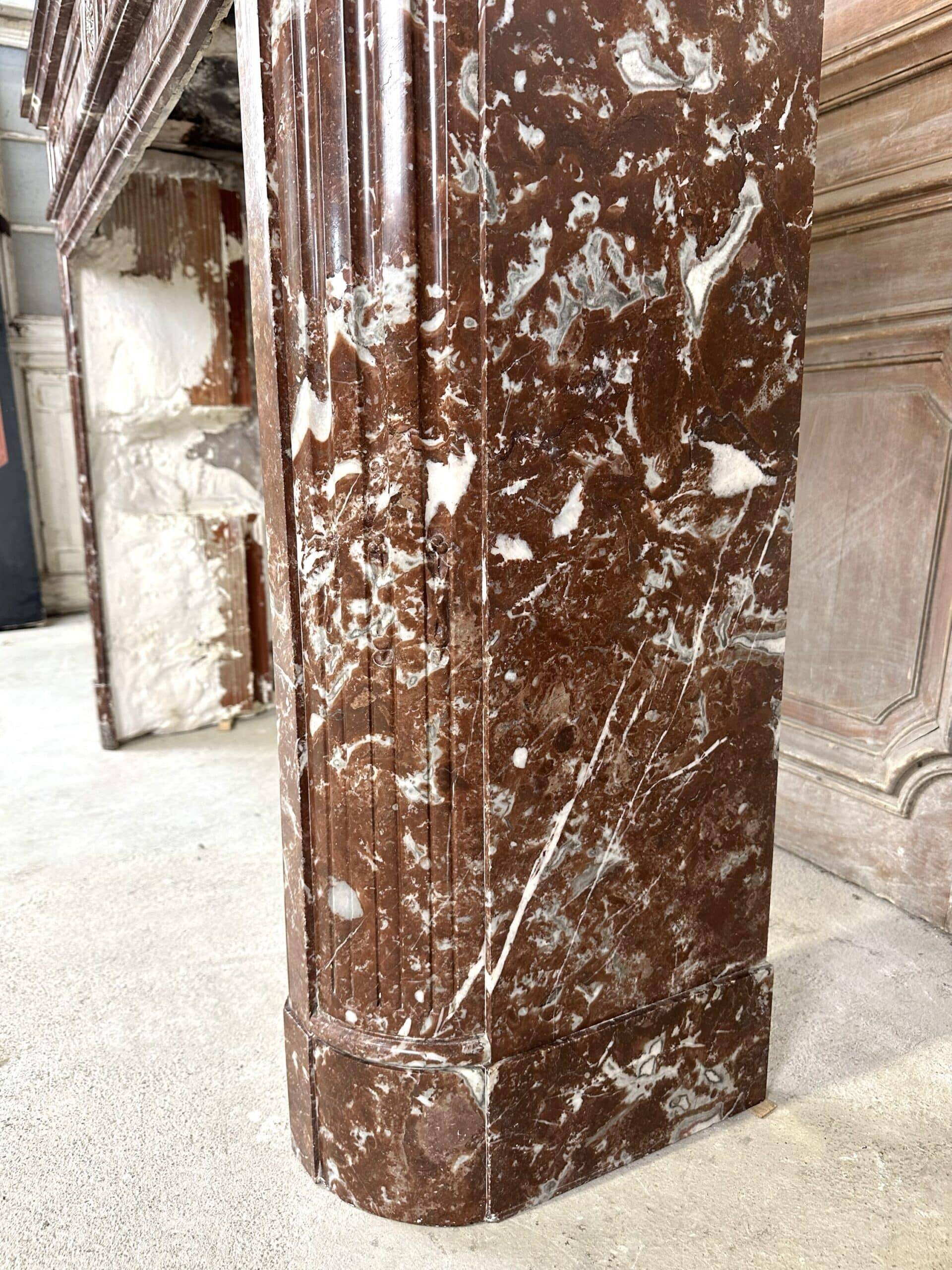 Red marble fireplace in the Louis XVI style, late 19th century