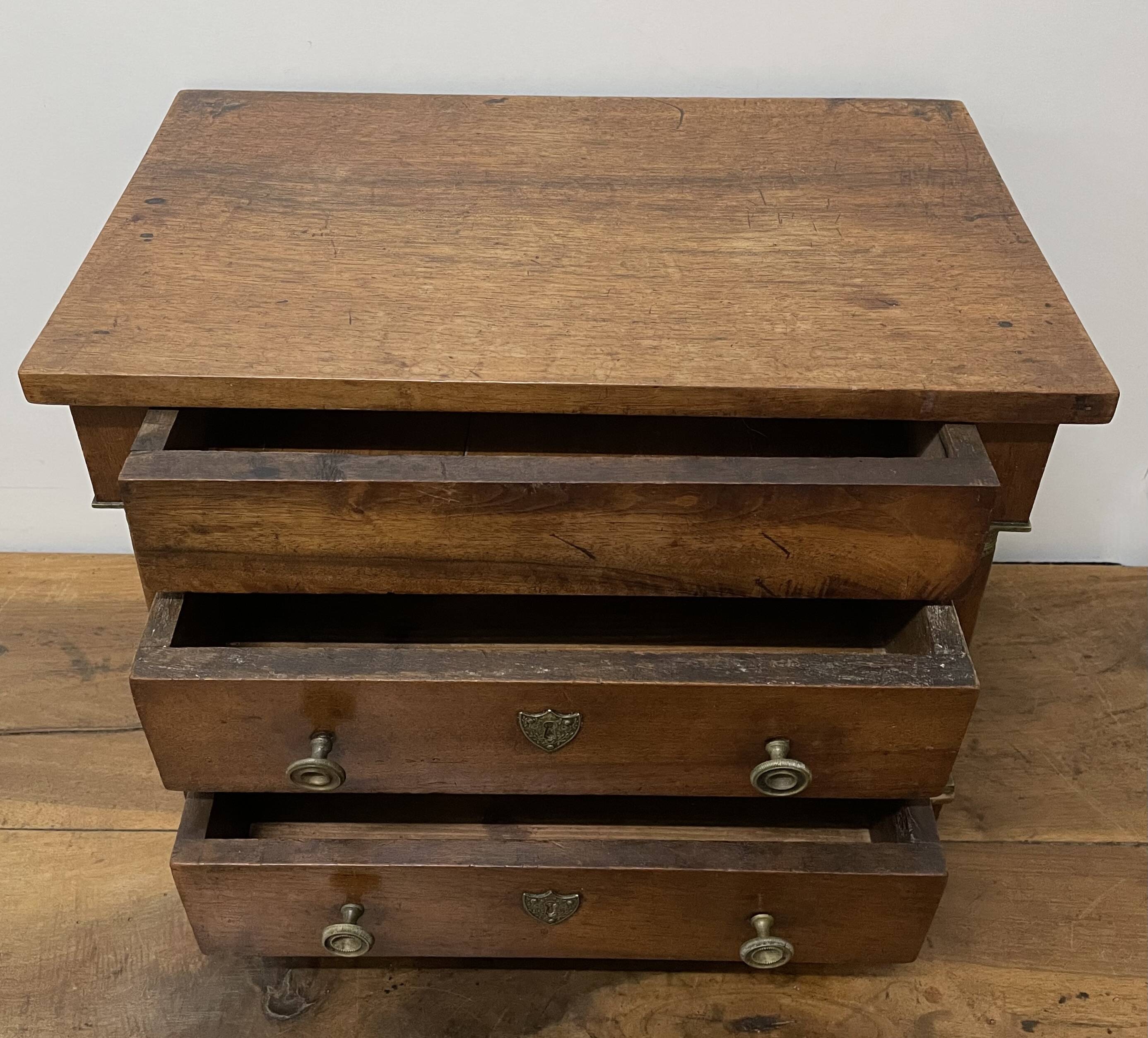 19th century Empire style walnut chest of drawers. It opens with 3 drawers in
