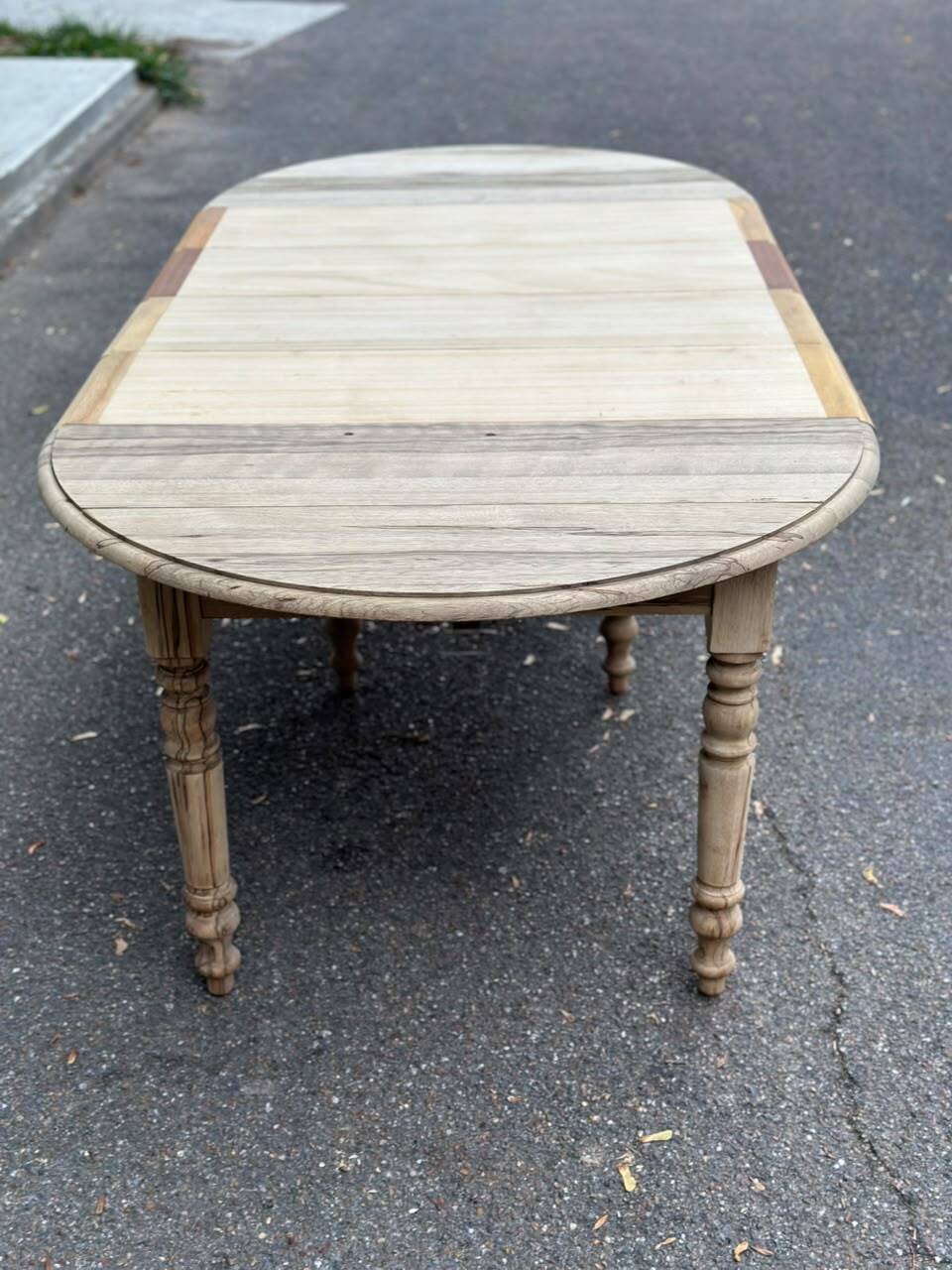 Round extendable dining table with flaps, stripped in raw oak, with 4 extensions.
