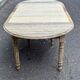 Round extendable dining table with flaps, stripped in raw oak, with 4 extensions.