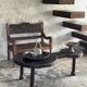 Small antique Indonesian bench in carved teak with plant and floral motifs.