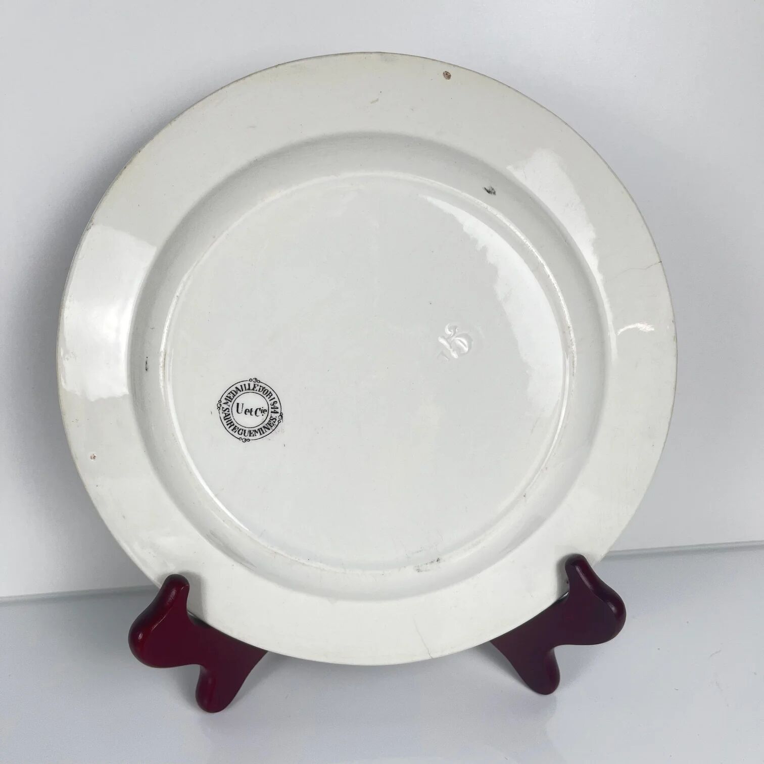 Set of three antique Sarreguemines U&C plates with hunting decoration from 1850 - 19th century black earthenware featuring a doe, chamois, and fox.