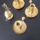 Many candlesticks and a small oil lamp.
