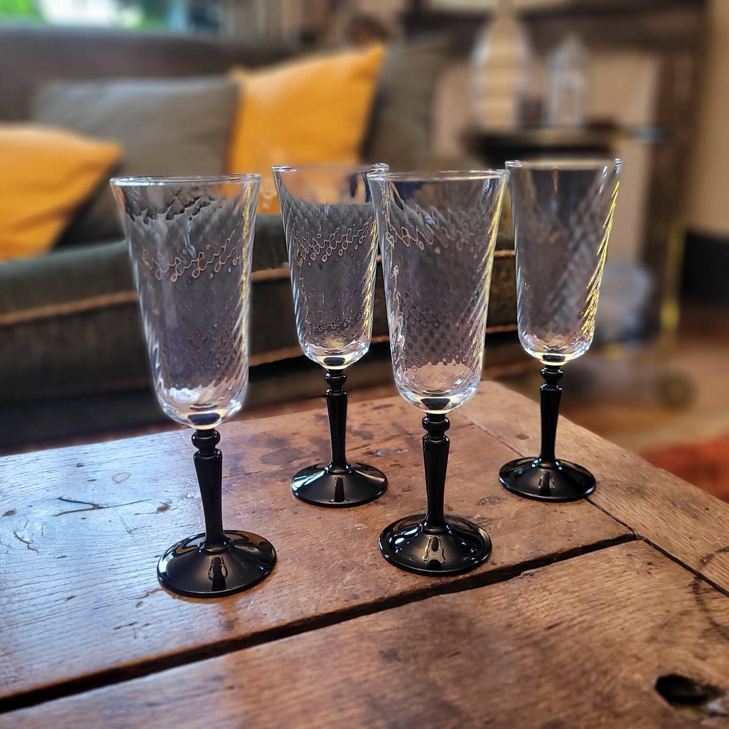 4 clear glass flutes with black stems. 1960–1970. 4 clear glass flutes with black stems.