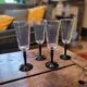4 clear glass flutes with black stems. 1960–1970. 4 clear glass flutes with black stems.