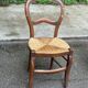 Vintage solid oak chair with rush seat, Louis Philippe style from the 20th century.