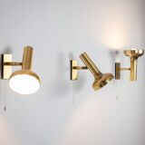 Set of three brass adjustable wall lamps
