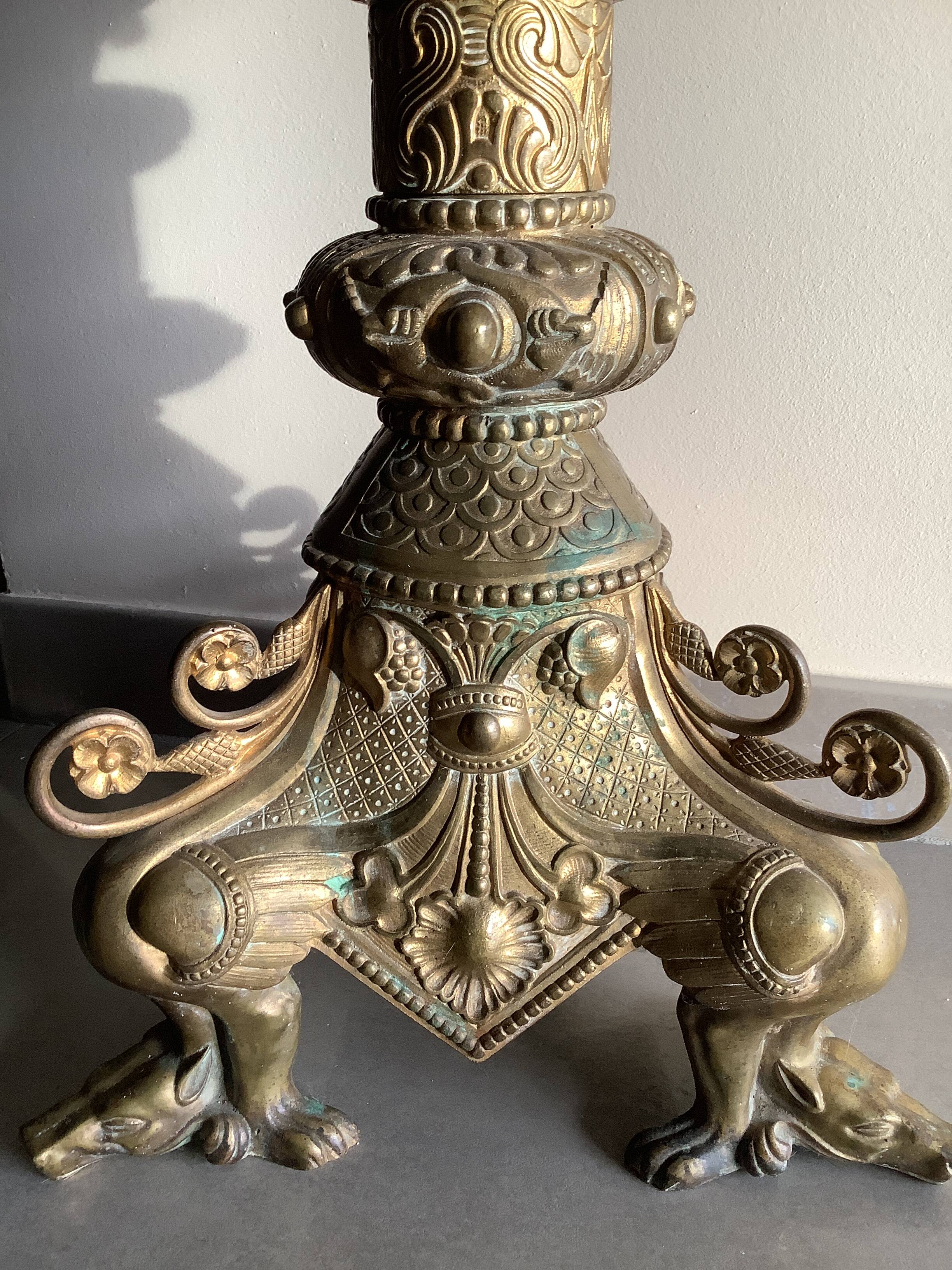 Large bronze candlestick with tripod and winged dog decoration, 19th century.