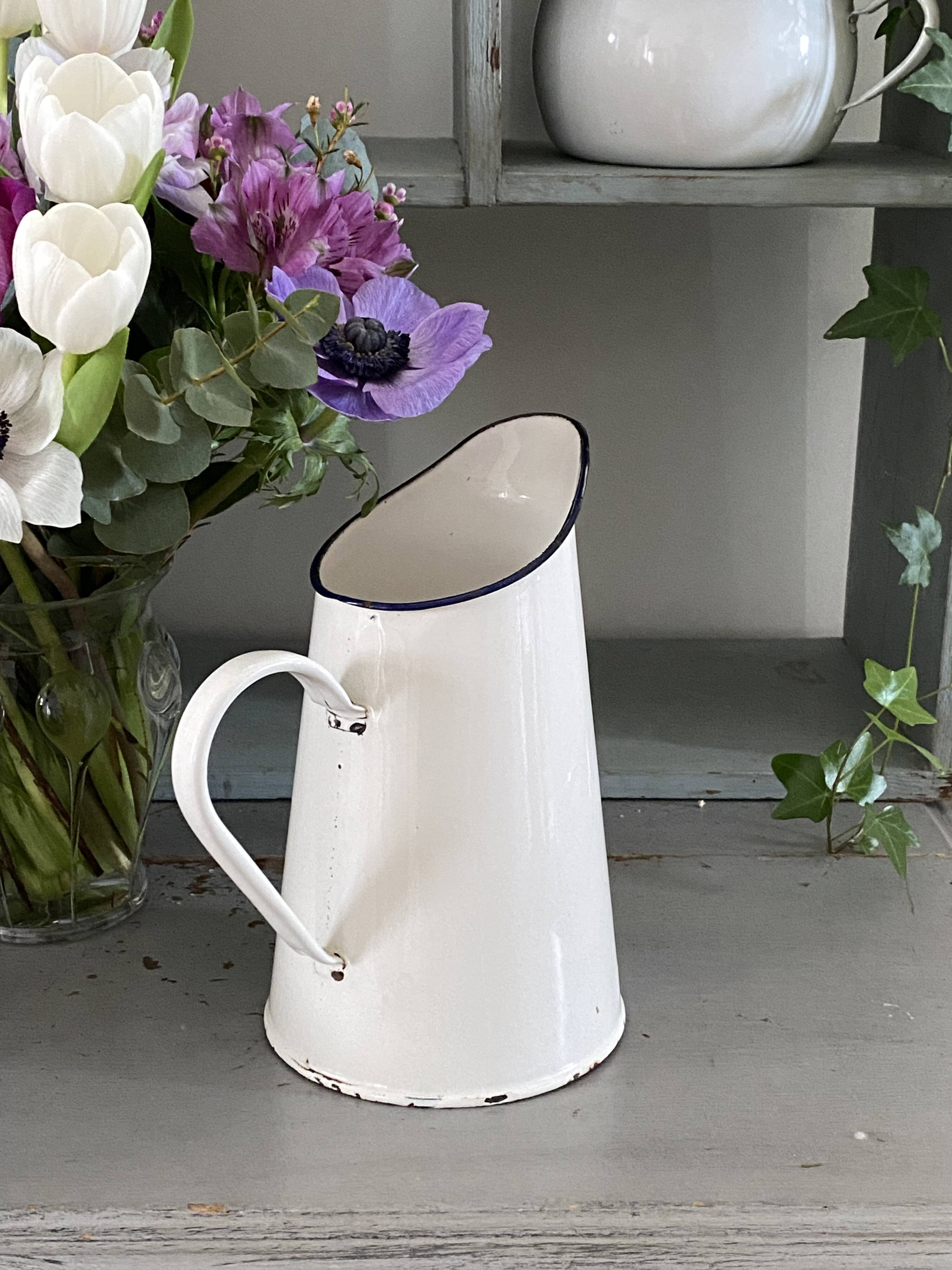 Old white enameled pitcher