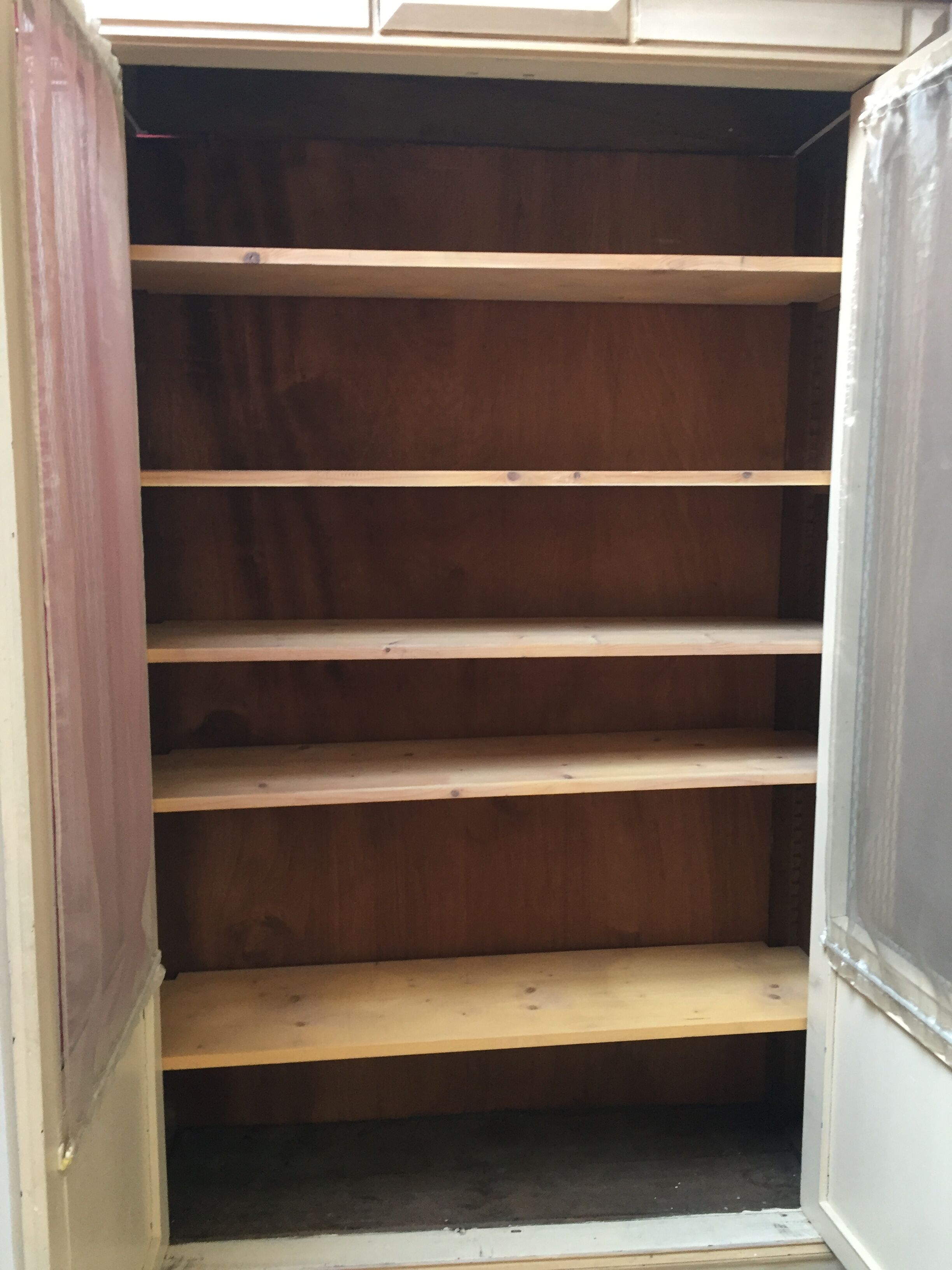 Bookcase 2 painted in ochre and cream mesh doors beginning 20 th