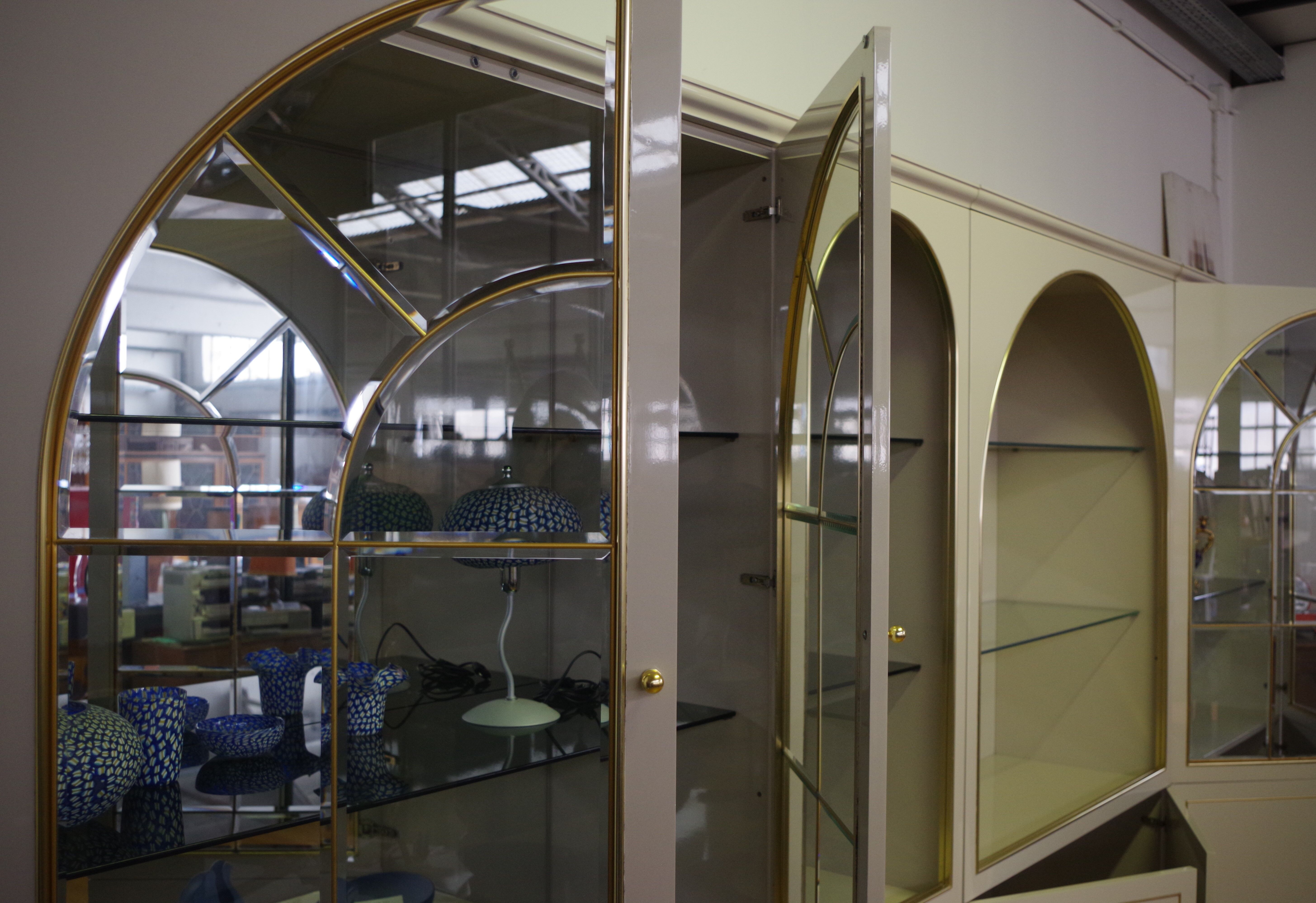 Showcases in lacquered wood, glass and brass  1970s, set of 4