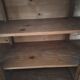 Antique wooden sideboard with three sliding glass doors.