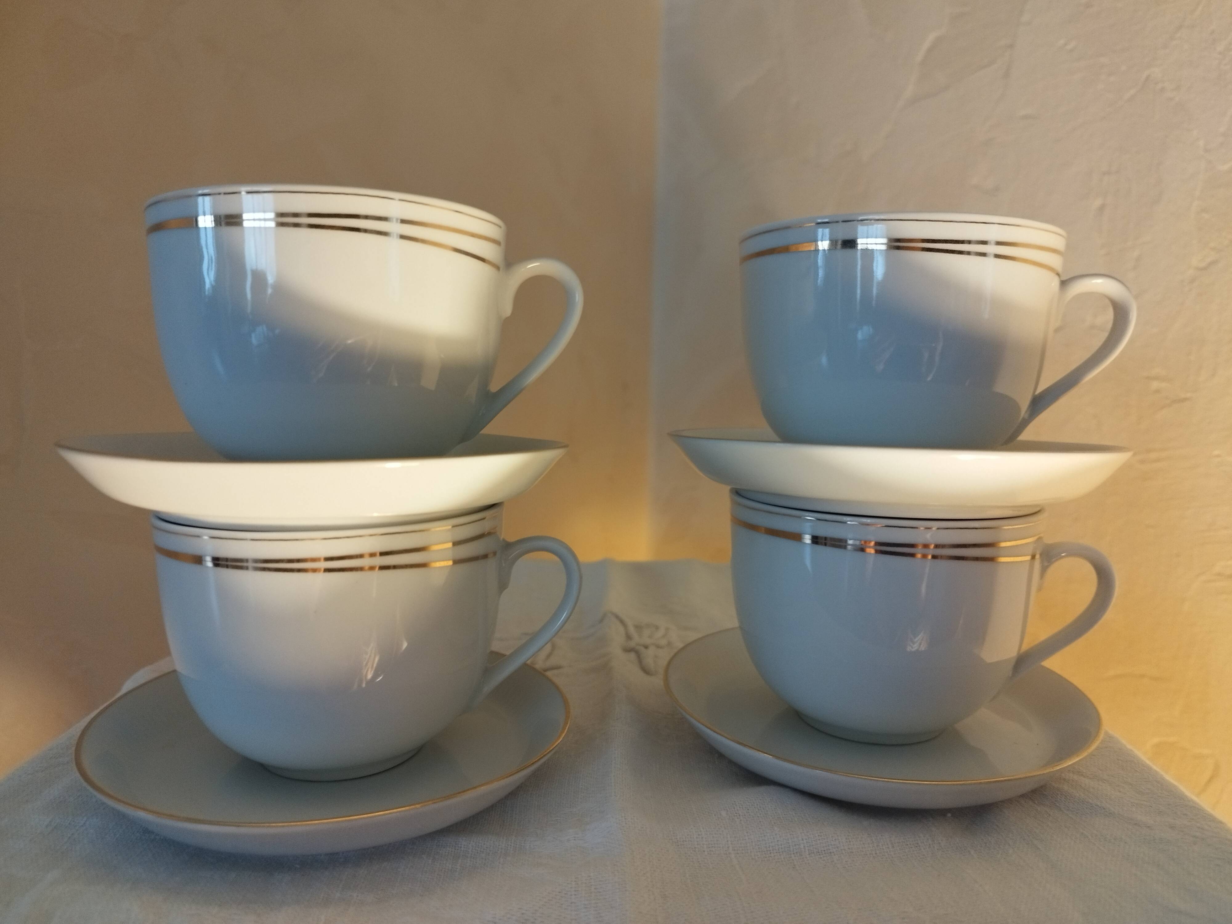 Set of 4 white and gold porcelain cups