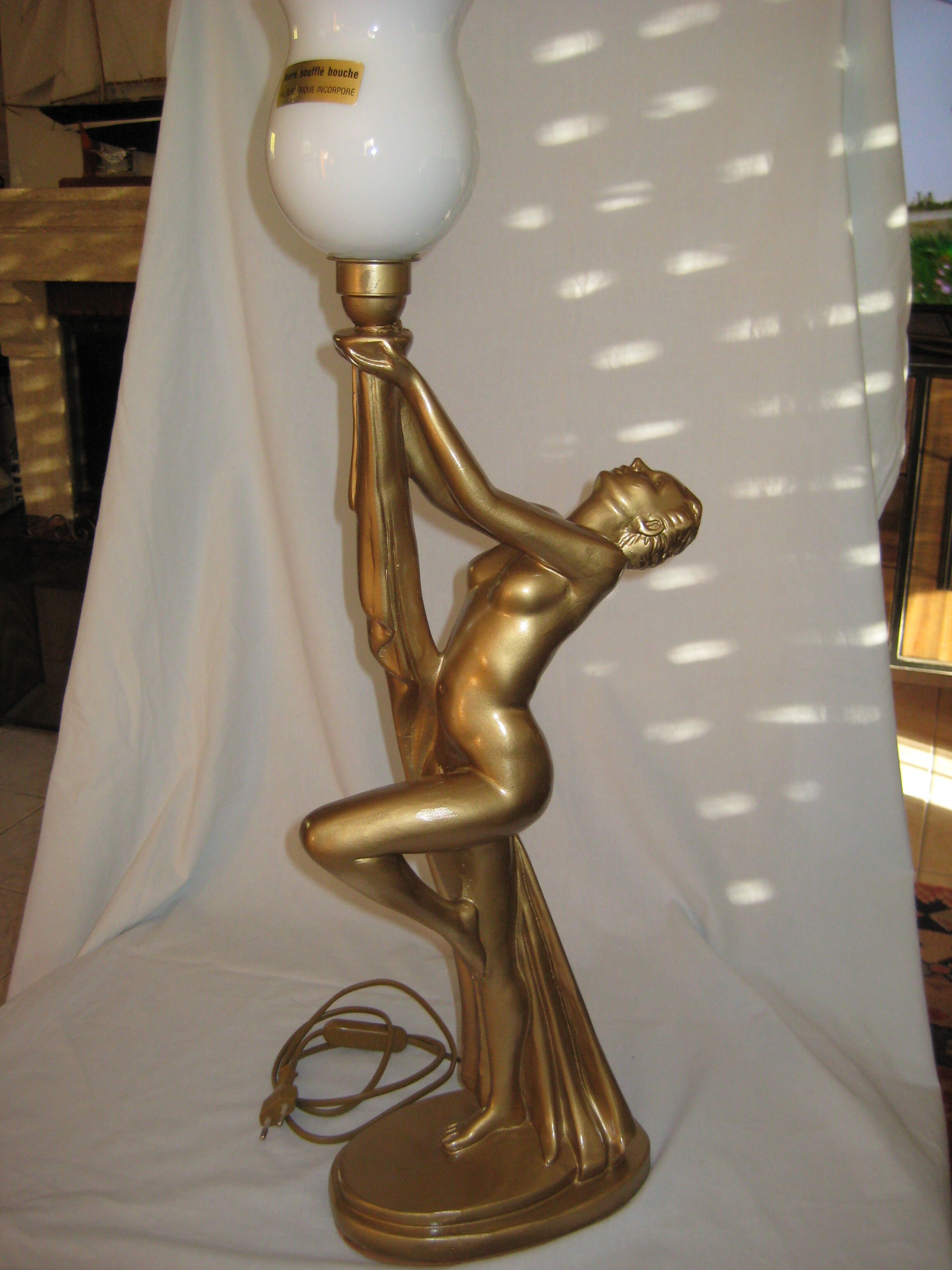 Lamp depicting a with a drape