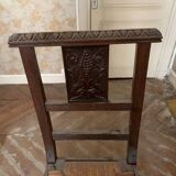 Antique carved wooden chairs with straw seats.