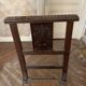 Antique carved wooden chairs with straw seats.