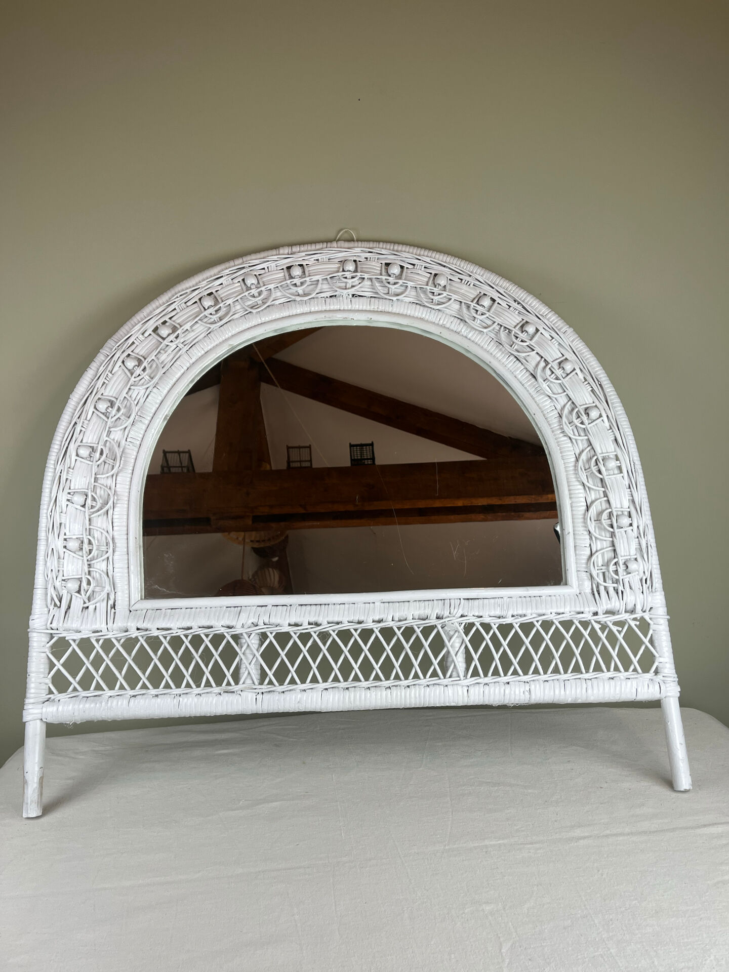 Half-moon wicker mirror