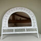 Half-moon wicker mirror