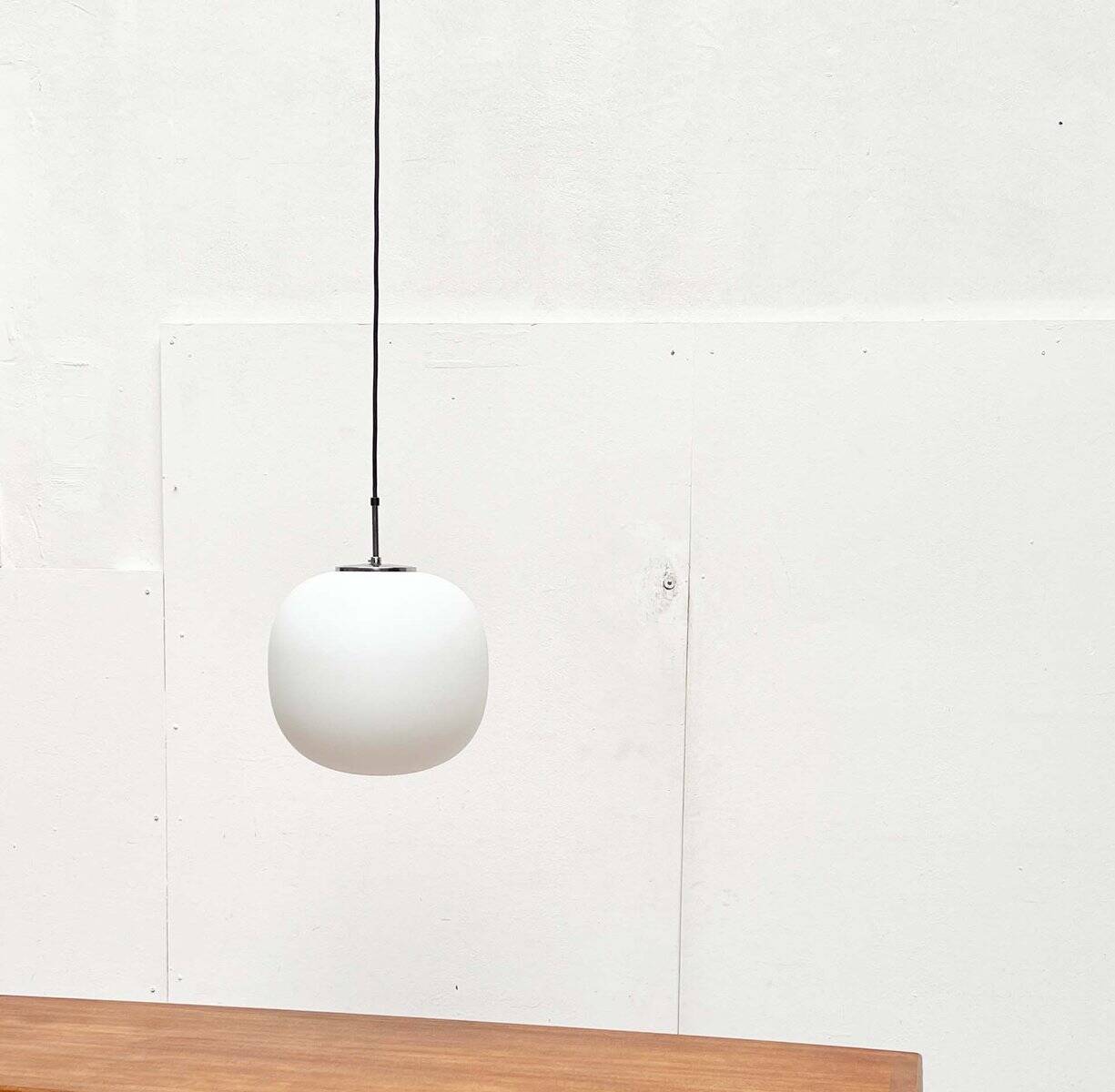 Minimalist suspended glass ball lamp from the vintage German space age by Glashütte Limburg, 1970s.