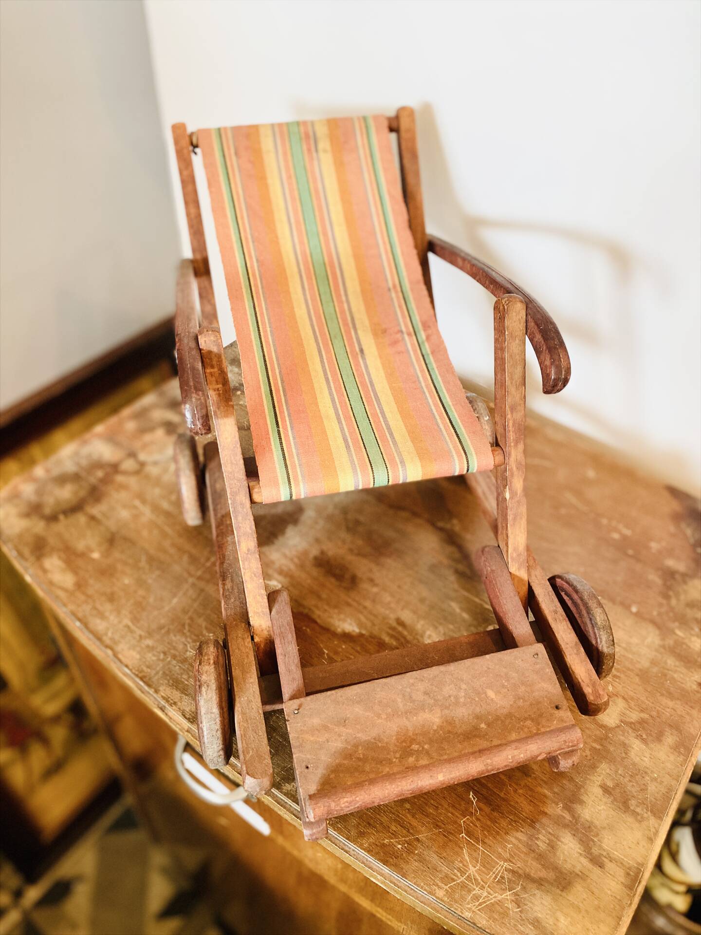 Vintage wooden folding doll's deckchair on wheels