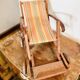 Vintage wooden folding doll's deckchair on wheels