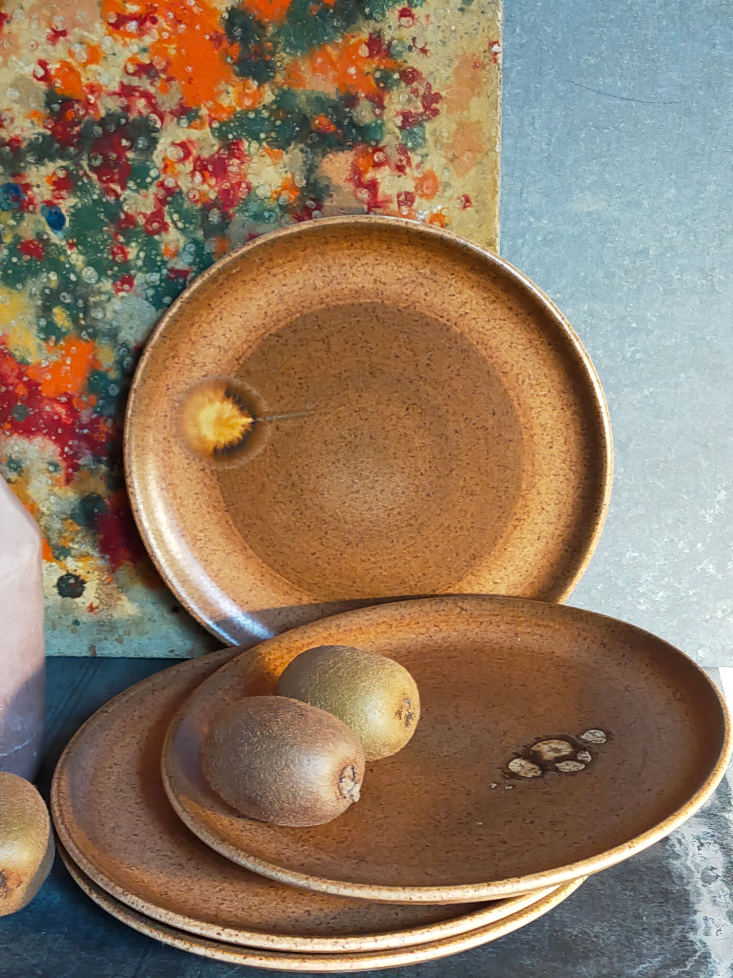 Four vintage glazed stoneware potter's plates