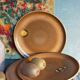 Four vintage glazed stoneware potter's plates