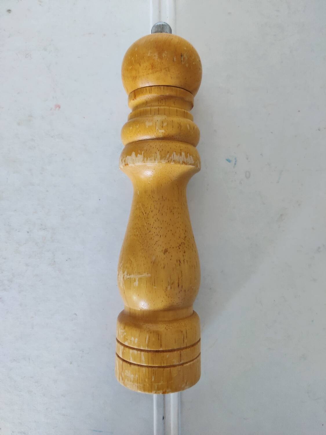 Turned wooden pepper mill