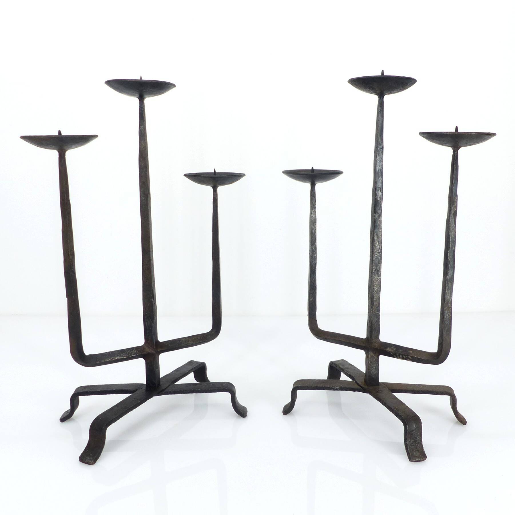 Pair of brutalist wrought iron candlesticks, France, three lights, signed