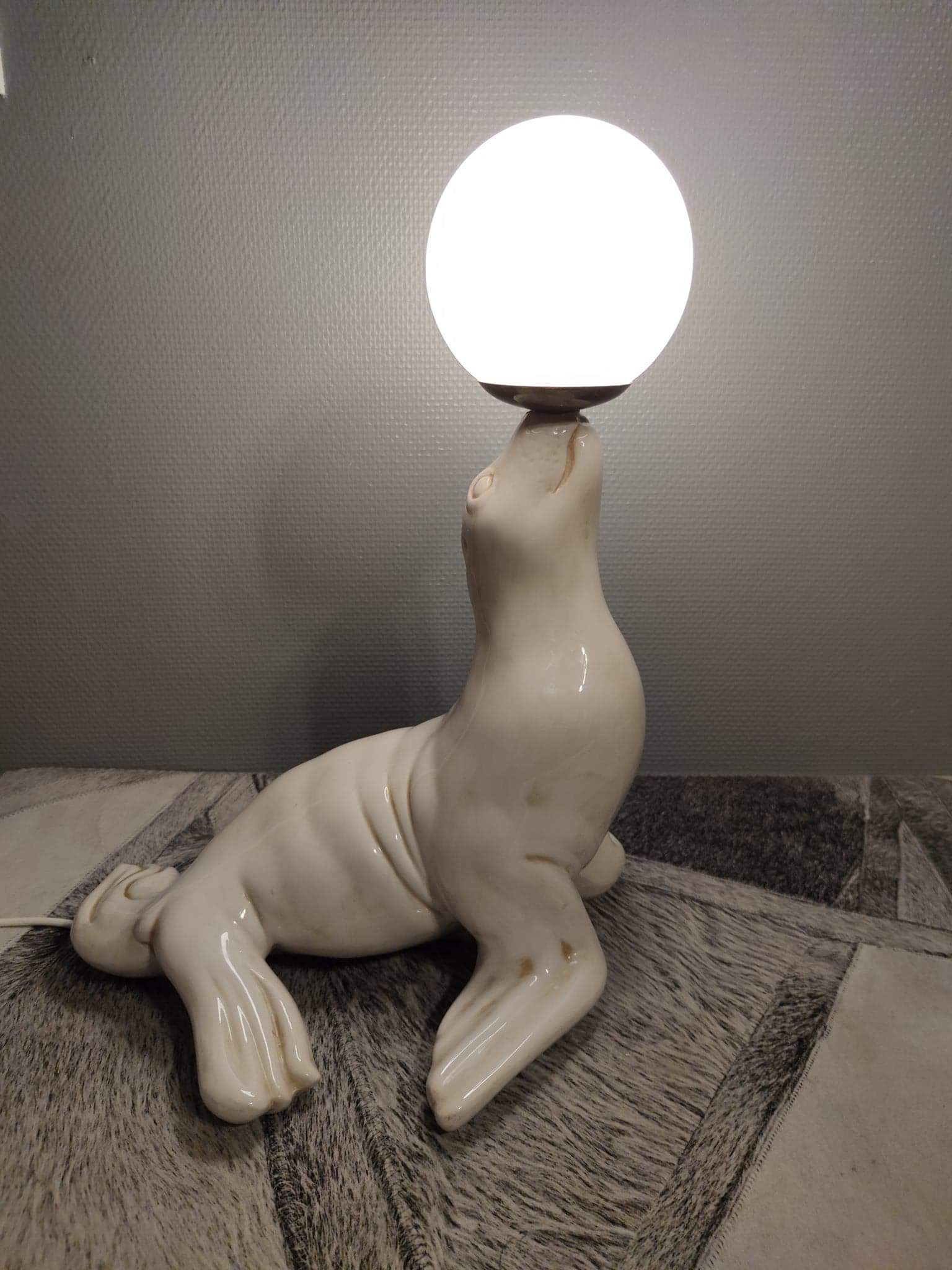 White ceramic sea lion lamp and opaline globe