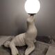 White ceramic sea lion lamp and opaline globe