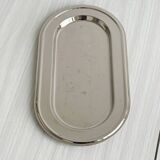 Small antique tray made of lightweight metal.