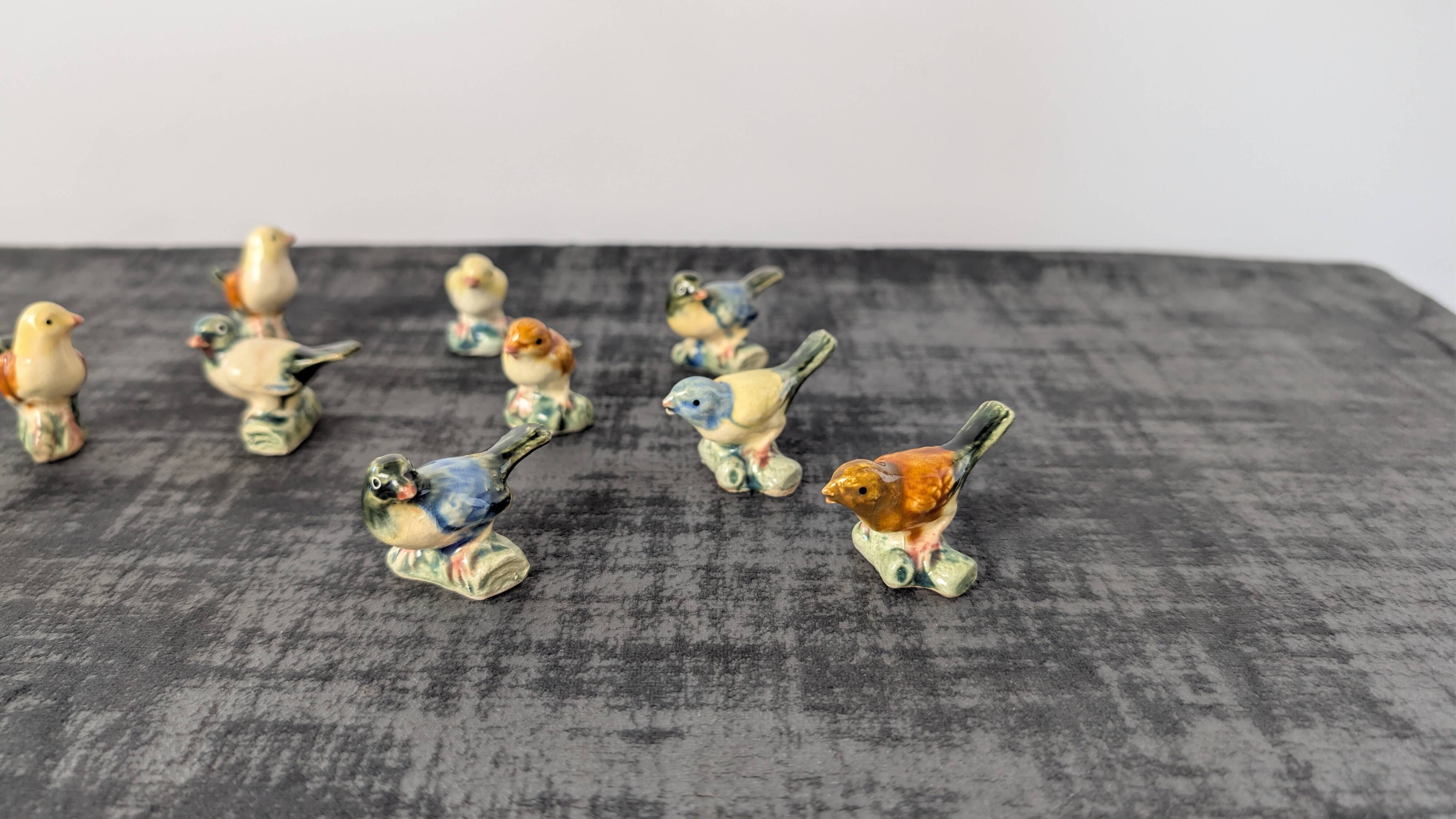 Set of 11 miniature birds in polychrome glazed ceramic.