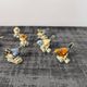 Set of 11 miniature birds in polychrome glazed ceramic.