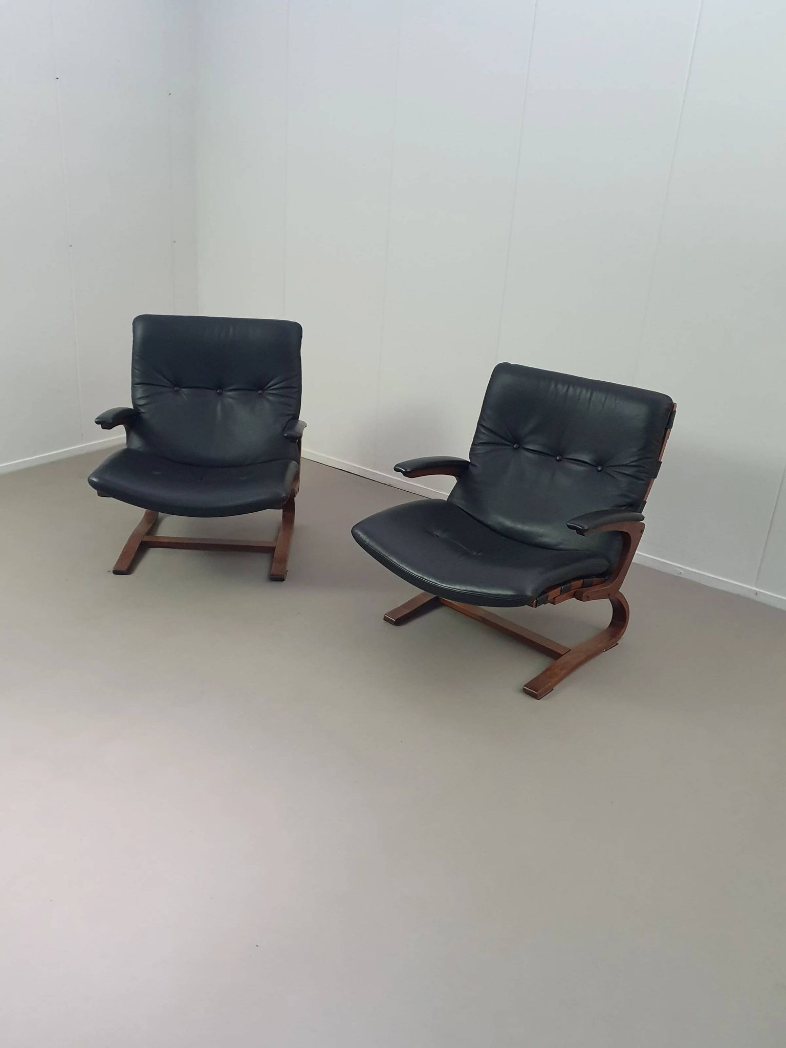 2 x Scandinavian black leather lounge chairs
