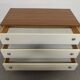 Low chest of drawers with 3 drawers in mahogany and white satin, France circa 1980.