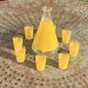 Liqueur service composed of a glass carafe and 8 small yellow screen-printed glasses
