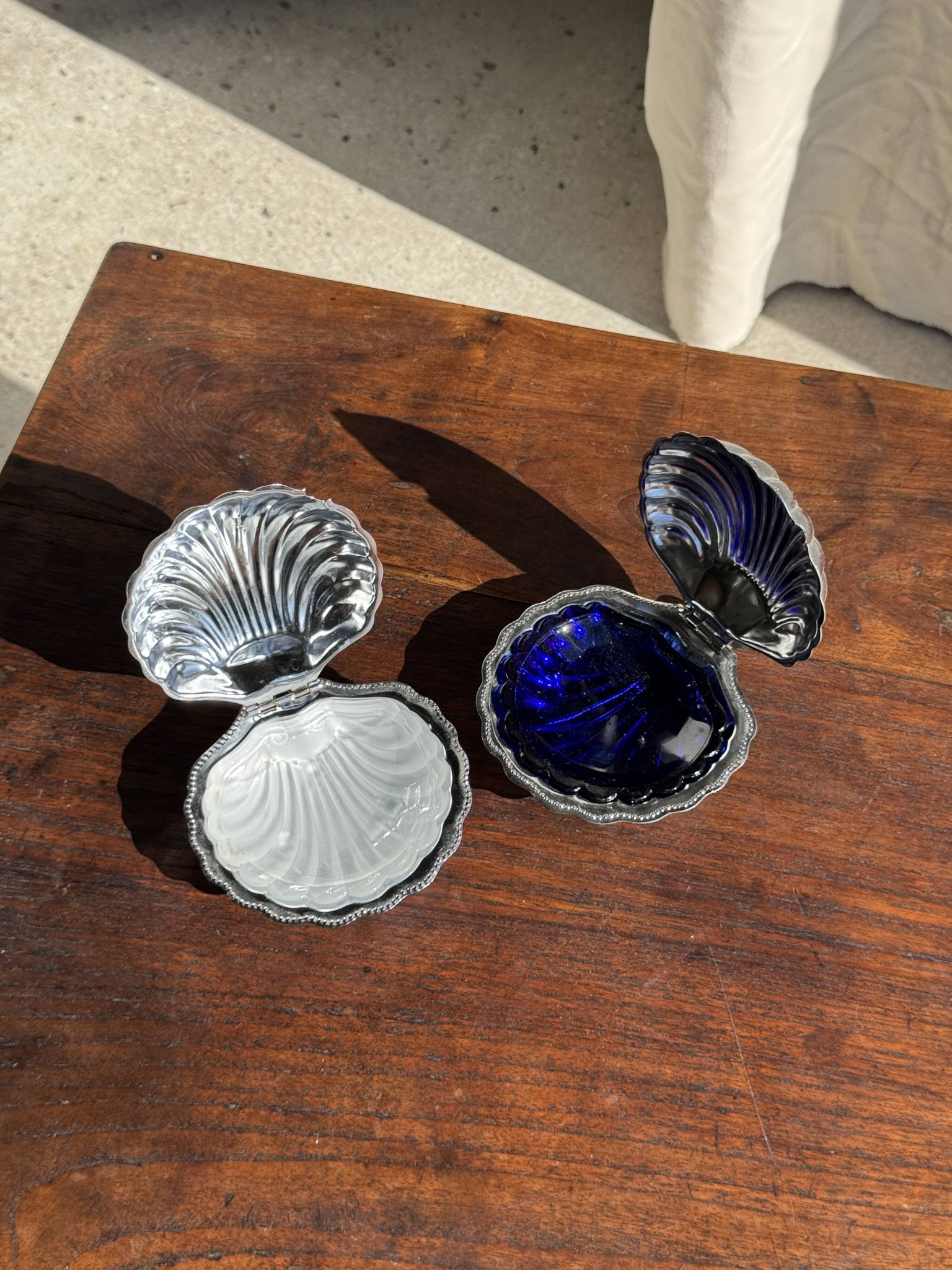 Vintage silver-plated shell butter dish with blue bowl.