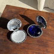 Vintage silver-plated shell butter dish with blue bowl.