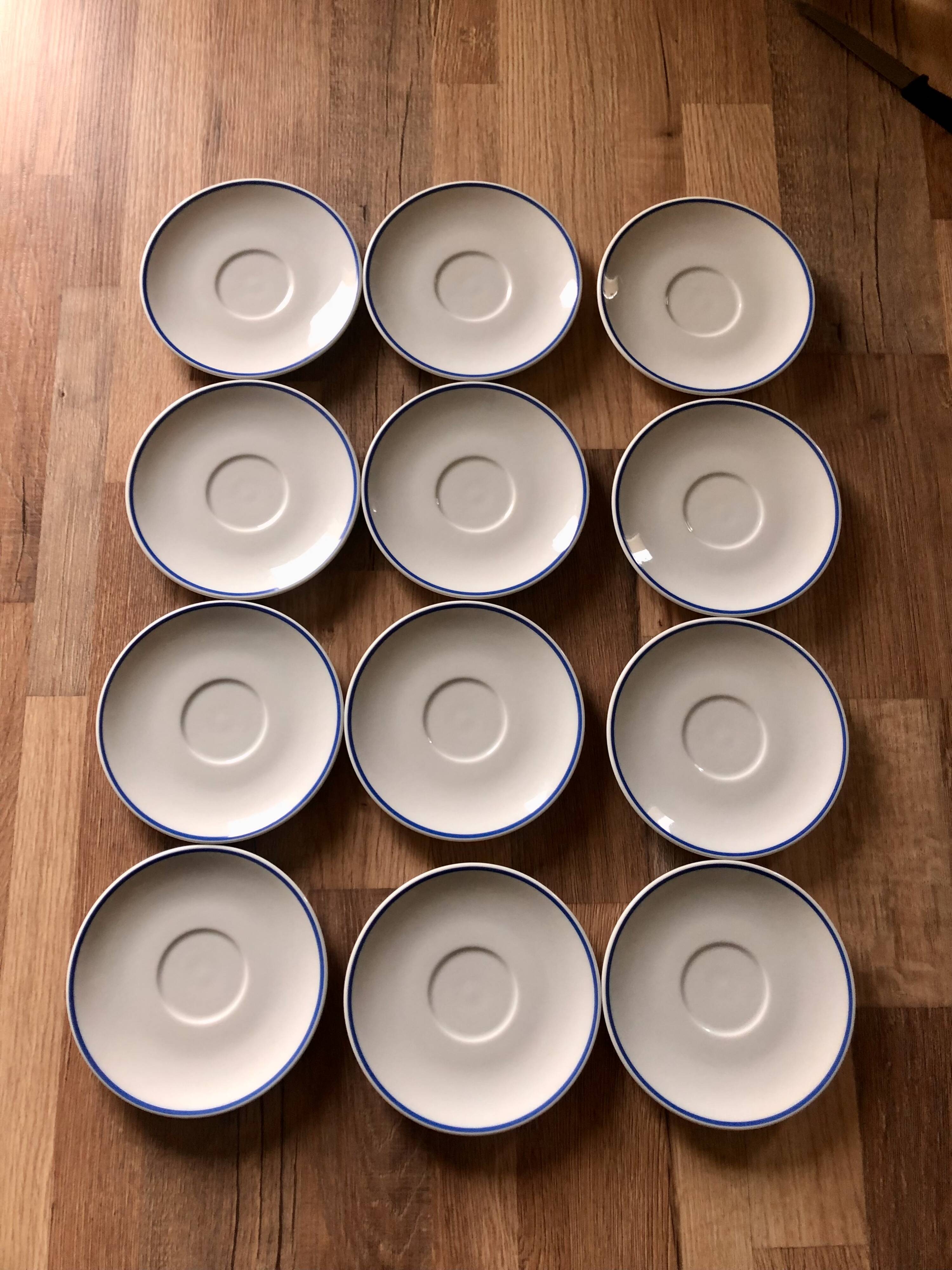 Set of 12 white porcelain saucers with blue edging
