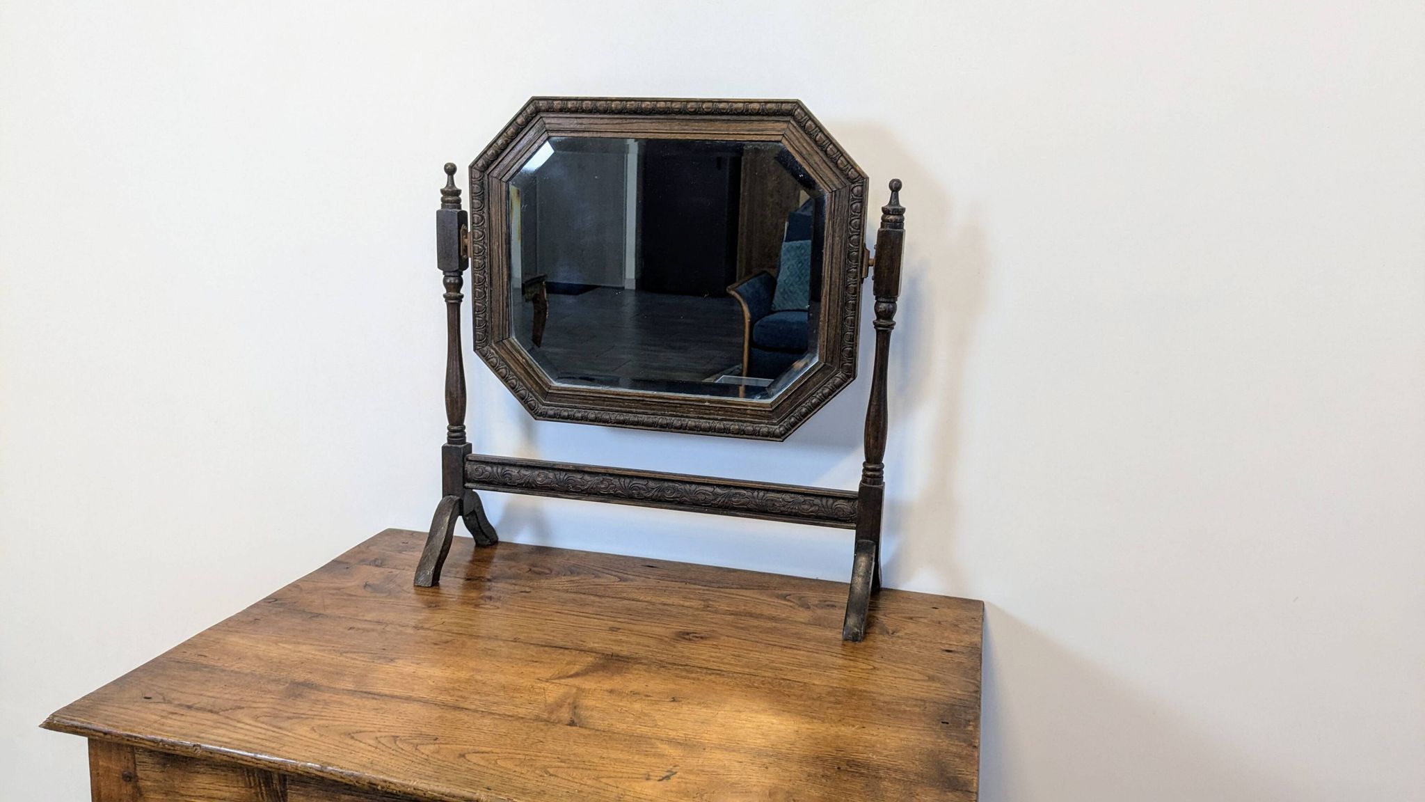 Antique beveled octagonal vanity mirror in carved wood