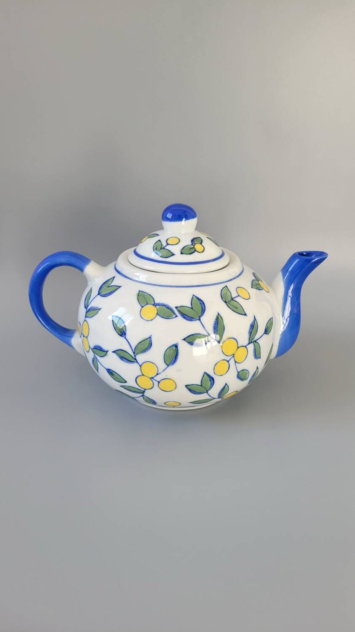 Blue teapot and yellow fruits