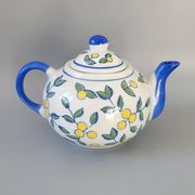 Blue teapot and yellow fruits