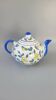 Blue teapot and yellow fruits