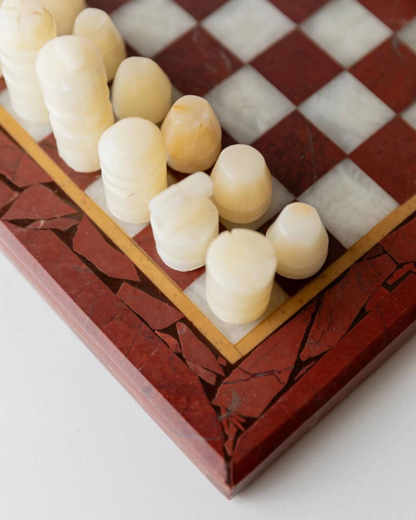 Vintage marble chess set from the 1960s, cream, burgundy and gold board with metal inlay, stone pieces.