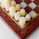 Vintage marble chess set from the 1960s, cream, burgundy and gold board with metal inlay, stone pieces.