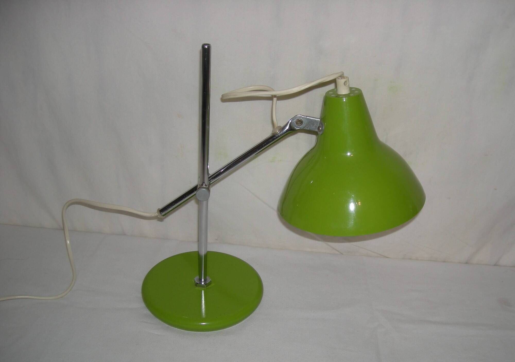 Green desk lamp with an arm from the 1970s.