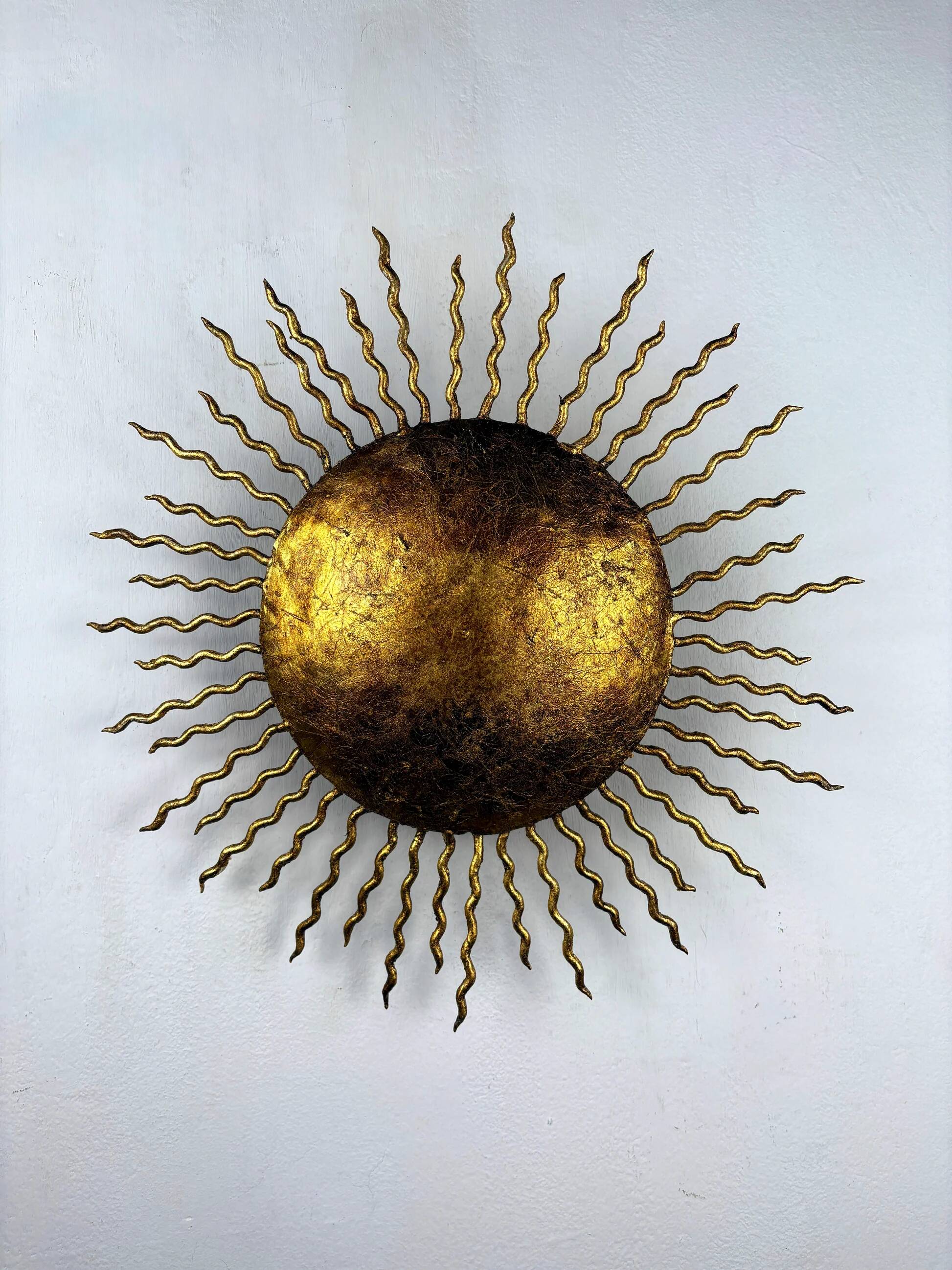 French gilt metal sunburst light fixture, Gilbert Poillerat, 1930s France