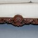 Three-seater canapé carved from solid walnut with claw feet.